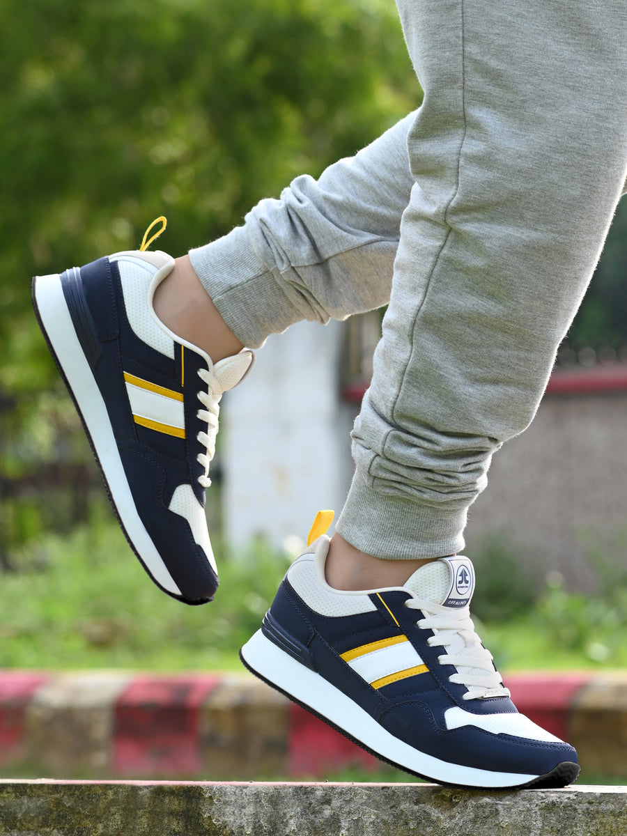 Shop Classic Navy Men's Sneakers with Yellow Detailing Shop Classic Navy Men's Sneakers with Yellow Detailing